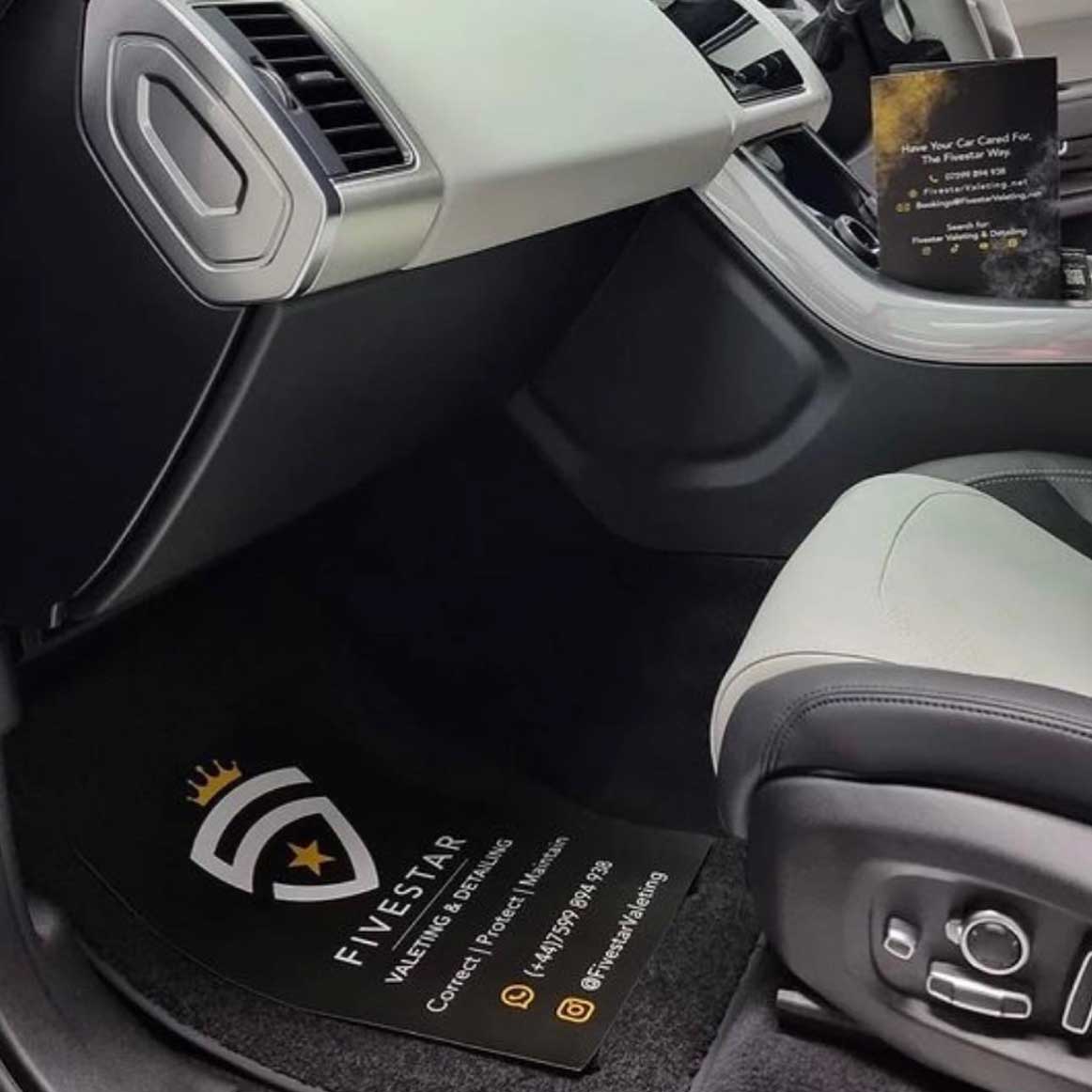 Custom-designed paper floor mat featuring brand logo in a spotless car interior